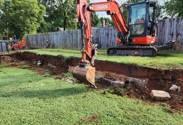 Large excavator removing dirt on excavation project by Storm Valley Landscape