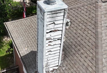 Chimney with rotted siding, leaks, and damaged trim requiring repair — services include siding repla