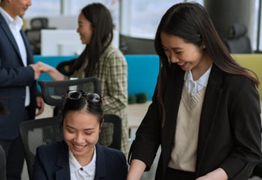 a woman in a suit and tie is smiling at a laptop