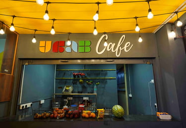 a storefront of a coffee shop with a yellow ceiling