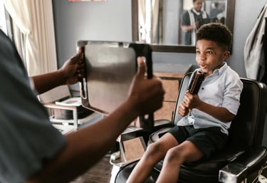 a boy in a chair with a tie on his tie