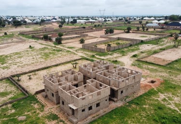 a building with a large building in the middle of a field