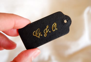 Hot foiling on leather bag tag with initials by NYC calligrapher Handwritten by Belle.