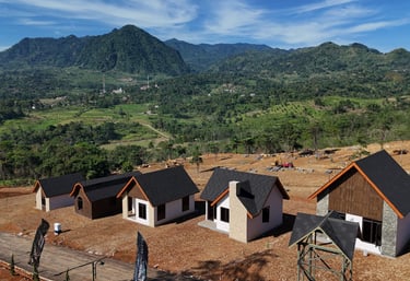 a group of houses with a mountain in the background