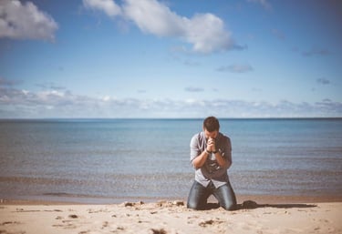 over worked man seeking help on the beach