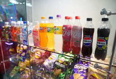 a display case with Asian exotic chips and soda bottles and candy