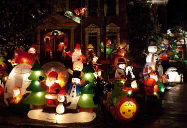 yard full of christmas lights and inflatable decorations