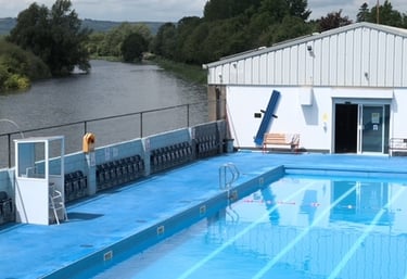 a swimming pool with a swimming pool and a boathouse