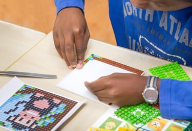 Human creating a picture with hands using transparent baseplate and colorful pixel squares
