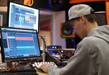 a man in a recording studio mastering tracks with cubase listen on a professional monitoring 