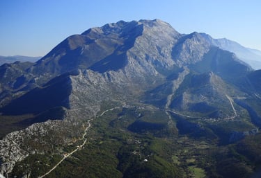Aerial view of Biokovo mountain with rocky peaks and Adriatic Sea coastline.