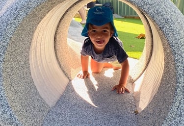 child playing in tunnel