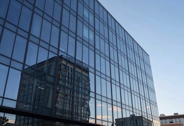 Architectural photography of a modern glass-walled tech park in Ukraine during the blue hour. Reflections of light blue and dark blue on the glass facade, symbolizing innovation.