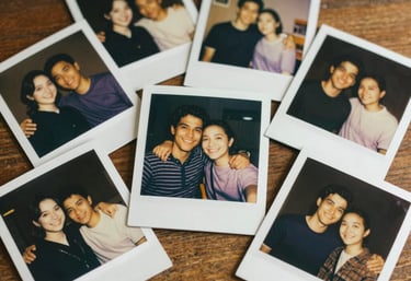A series of Polaroid photos scattered on a wooden table, showing happy people in warm lighting. Nostalgic and cinematic mood.