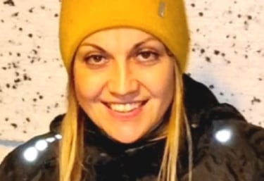 a woman in a yellow hat and black jacket