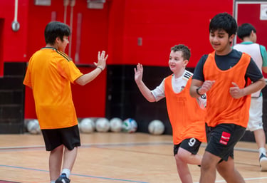 MVB FC kids playing indoor soccer, giving each other high fives sports match. Mississauga