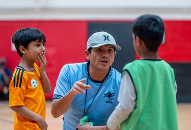 A youth soccer MVB FC coach talking to young players during indoor practice in Mississauga