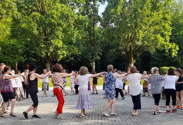 a group of people standing around a circle with their arms outstretched out
