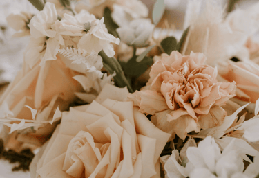 a bouquet of flowers in a vase on a table