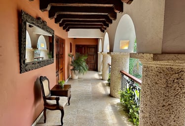 a long hallway with a chair and a mirror
