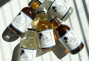 several recyclable glass bottles of blue magnolia simple syrup