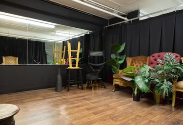 a photo studio with large mirror and black walls