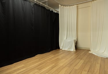 a photo studio with ivory curtains