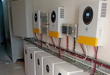 Multiple solar hybrid inverters and lithium battery storage units installed in a commercial power room.