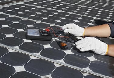 A technician performing solar panel maintenance using a multimeter and tools on a residential roof.