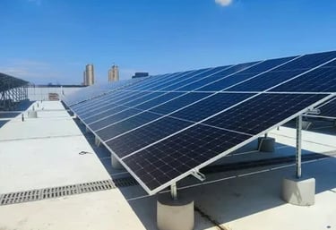 A commercial rooftop solar panel installation under a clear blue sky providing renewable energy.