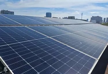 Residential rooftop solar panel installation on a tan tile roof for clean renewable energy.