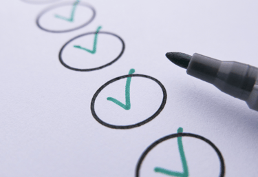 A pen and several circles of a checklist ticked off.