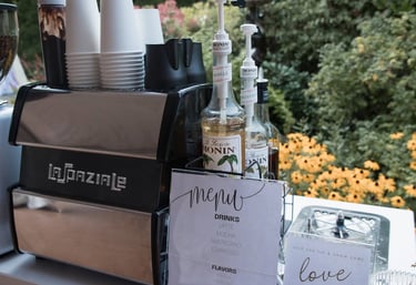 Espresso machine and flavored syrups set up for a corporate coffee cart event