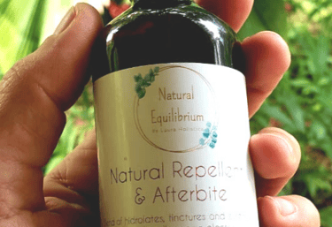 a person holding a bottle of natural products