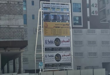 Project signage stand outside under construction building