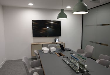 Xonference sstem and TV mounted on a wall in a boardroom