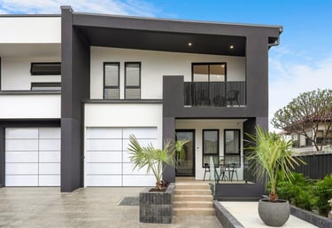 a house with a large white garage door and a large white garage door