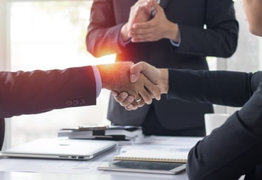 Two business professionals shaking hands to finalize a business services deal