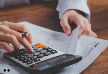 Person using a calculator to work on tax documents.