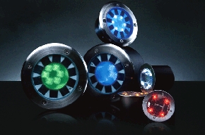 a group of four different colored lights on a table