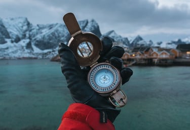 A hand holding a compass, symbolizing leadership and strategic direction.