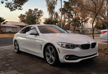 Clean white BMW sedan shining after Signature Detail package from Las Vegas mobile detailing.