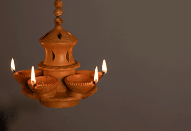 a clay potted with candles and candles