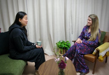A healthcare professional and patient having a supportive consultation in a comfortable clinic setting.