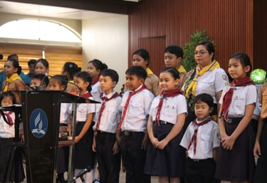 Groups of elementary students standing with scouts uniform