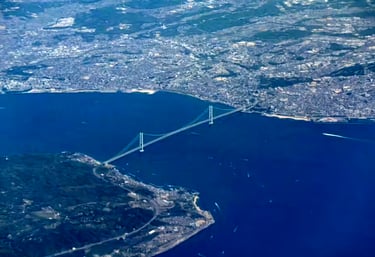 The Akashi Kaikyo Bridge, a bridge spanning a river with a bridge in the background