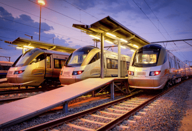 two trains parked at a train station