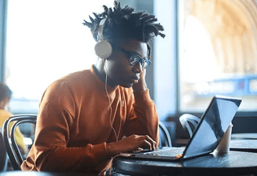 teen boy using laptop