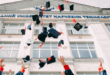 graduation mortorboards in the air