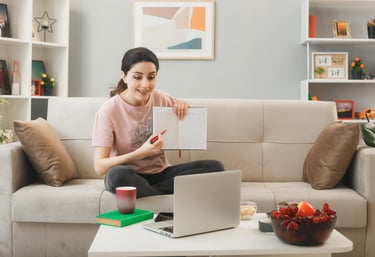 a woman sitting on a couch with a notebook and a notebook